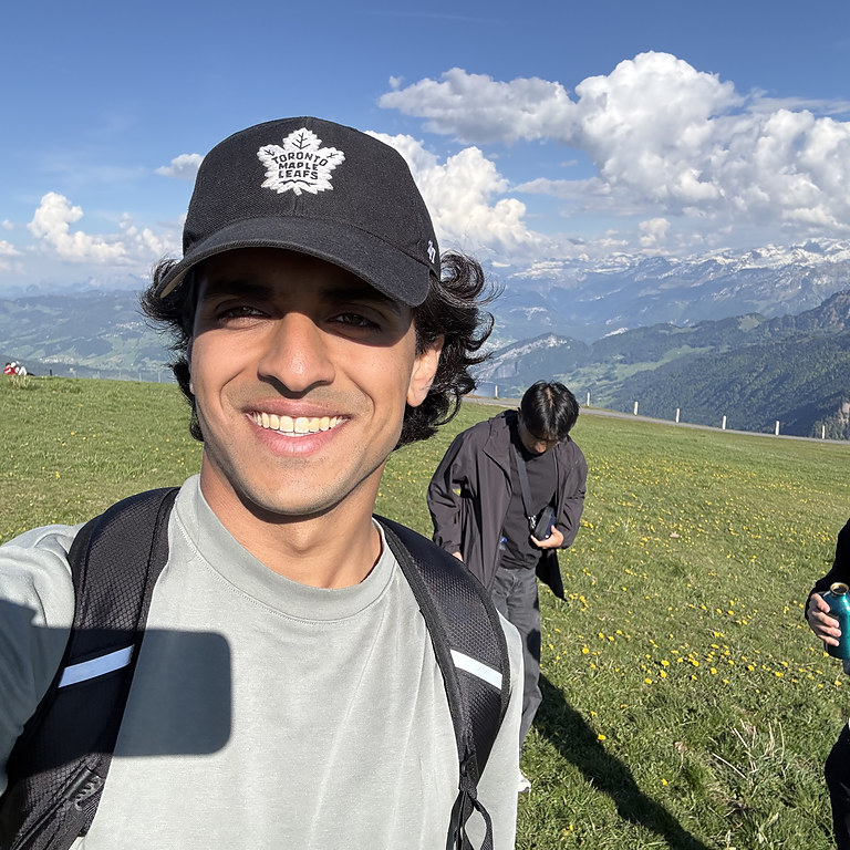 Sohail Sayed smiling in front of a mountain landscape